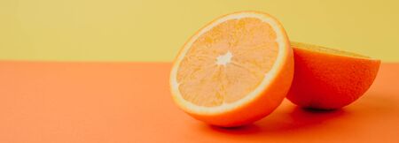 round juicy ripe orange slices on an orange and yellow background