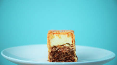 the cut cake rotates on a white plate