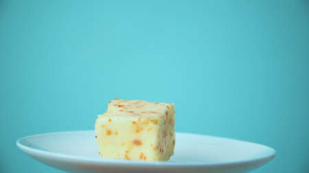 the cut cake rotates on a white plateの写真素材