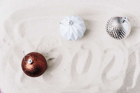 Christmas tree toys on white sand