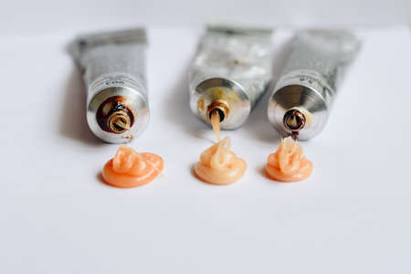 Squeezed out tubes of hair dye on a white backgroundの写真素材