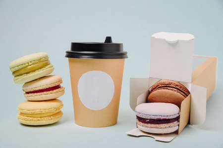 Several colorful macaroon cakes on a colored background 1