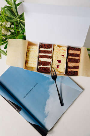 Set of cakes in icing and chocolate on a light background