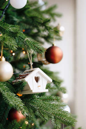 Wooden house Christmas toy on the Christmas tree
