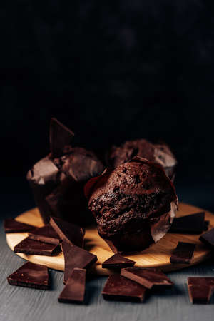 chocolate cupcakes close up on a dark background with bitter chocolate