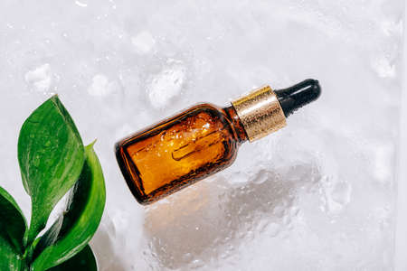 glass bottle with pipette with drops on it