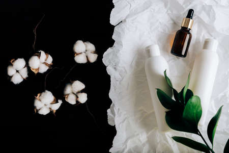 bottles of cosmetics on white crumpled paperの写真素材