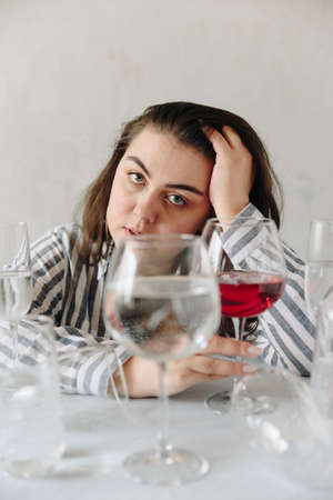 beautiful girl with glasses of water on the tableの写真素材