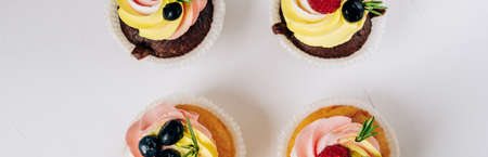chocolate cupcakes with cream and fresh berriesの写真素材