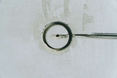 Holes in the concrete wall in the room for sockets