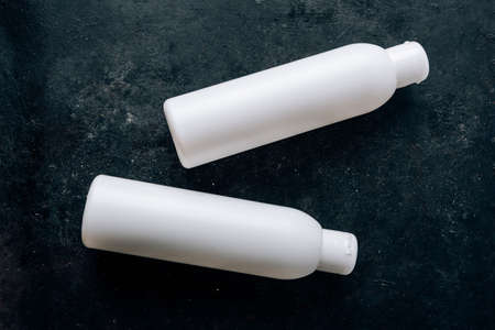 White bottle on a black surface, items for beauty and healthの写真素材