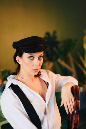 Portrait of a beautiful young woman in a white shirt and black pants in the Studioの写真素材