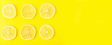 Lemon slices on a yellow Board close upの写真素材