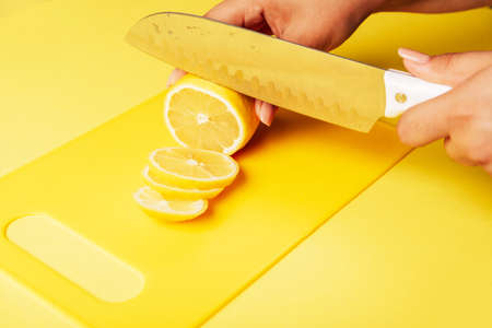 Lemon slices on a yellow Board close upの写真素材