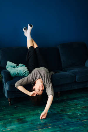 Beautiful young woman in gray sweater and disco ball at homeの写真素材