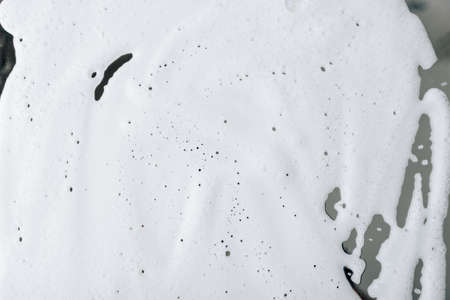 White foam smeared on the mirror close-upの写真素材