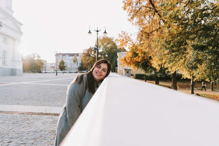 Portrait of a beautiful adult young woman on the background of autumn in the Park