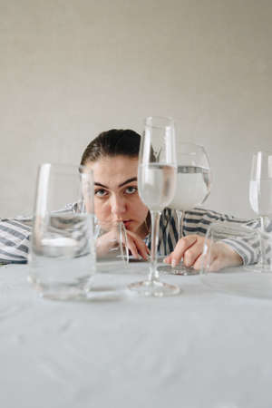 beautiful girl with glasses of water on the tableの写真素材