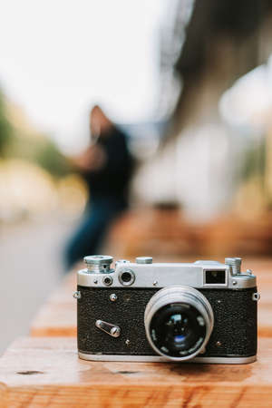Vintage camera on a wooden surface close-upの写真素材