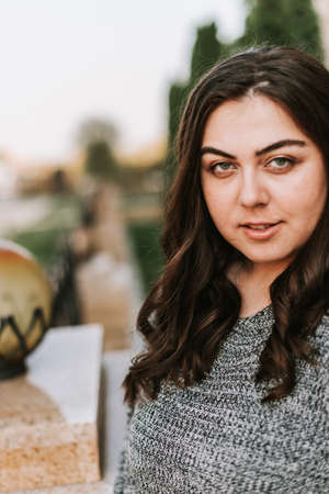 Portrait of a young adult girl on the background of a modern buildingの写真素材
