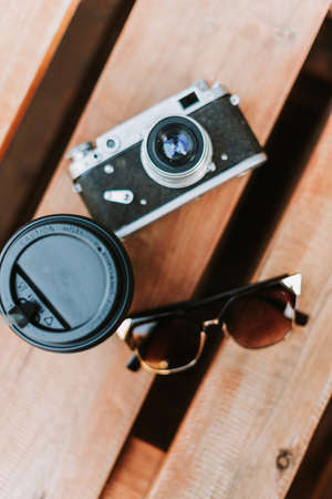 Vintage camera on a wooden surface close-upの写真素材