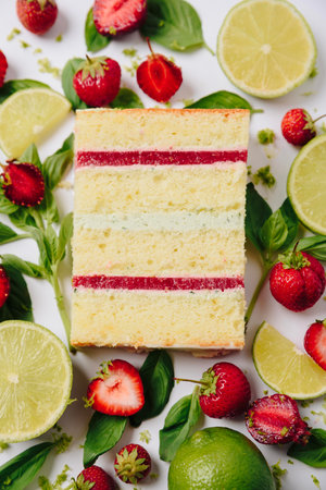 Slice of cake in the section on the background of fruitの写真素材