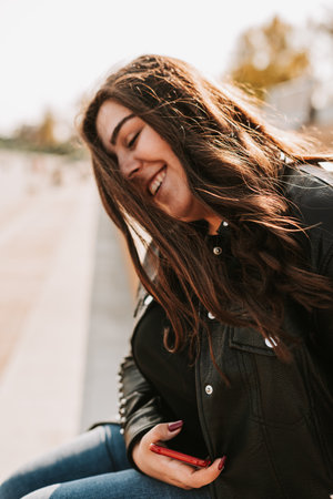 Large portrait of a beautiful woman in a leather jacket