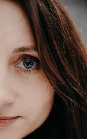 Portrait of a woman on the background of a snowy forestの写真素材