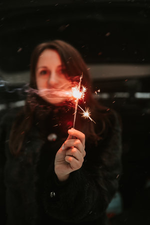 Portrait of a woman with sparklers in her handsの写真素材