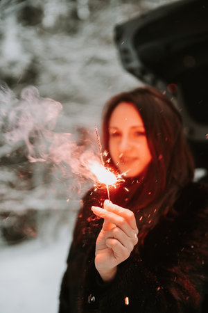 Portrait of a woman with sparklers in her hands