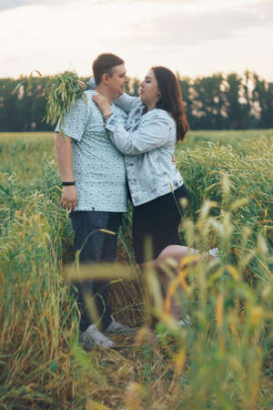 Young adult man and woman in a wheat fieldの写真素材