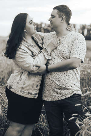 Young adult man and woman in a wheat fieldの写真素材