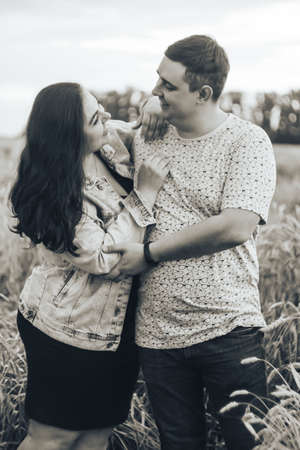 Young adult man and woman in a wheat fieldの写真素材