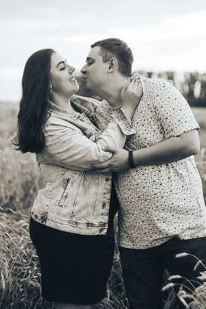 Young adult man and woman in a wheat fieldの写真素材