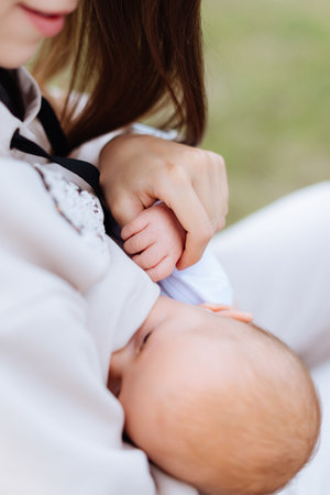 Baby's legs and mother's hands close upの写真素材