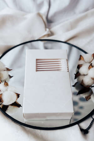 Cotton swabs in a white box and white cottonの写真素材