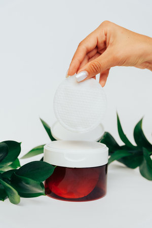 The girl's hand takes out a cotton pad from the box 1の写真素材