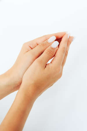 Hands of a young woman close up on a white backgroundの写真素材