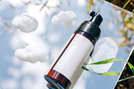 White tubes of cream in a field on a mirror surfaceの写真素材