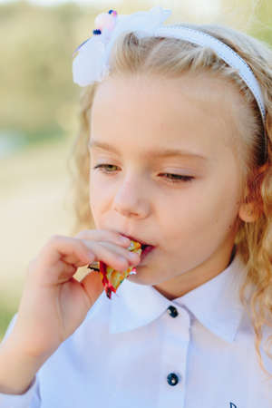 Children with candy in their handsの写真素材