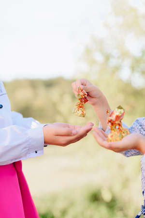 Children with candy in their handsの写真素材