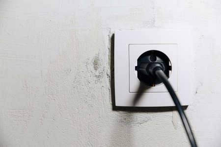 White socket with black plugの写真素材