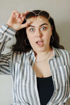 Large portrait of a beautiful surprised young womanの写真素材