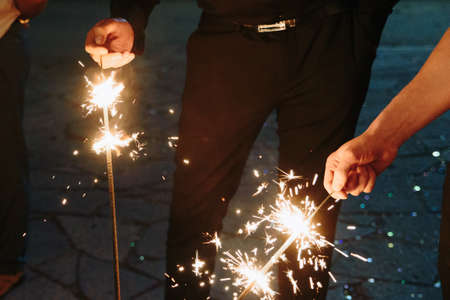 People set fire to sparklers close-upの写真素材