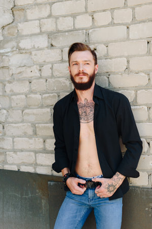 A handsome young man with a beard in a grunge-style interior 1の写真素材
