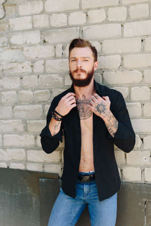 A handsome young man with a beard in a grunge-style interior 1の写真素材