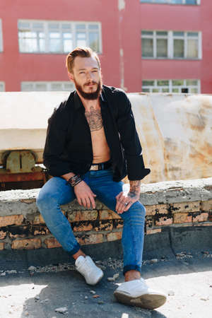 A handsome young man with a beard in a grunge-style interior 1の写真素材