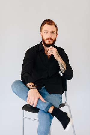 Studio photo of a beautiful young man with a beard