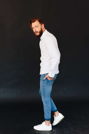 Studio photo of a beautiful young man with a beardの写真素材
