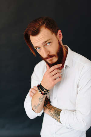 Studio photo of a beautiful young man with a beardの写真素材